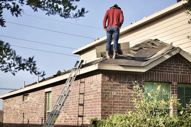 Professional roofer working on a residential roof in Little Elkhorn